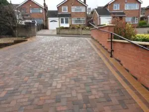 Elegant driveway featuring permeable block paving in a herringbone pattern