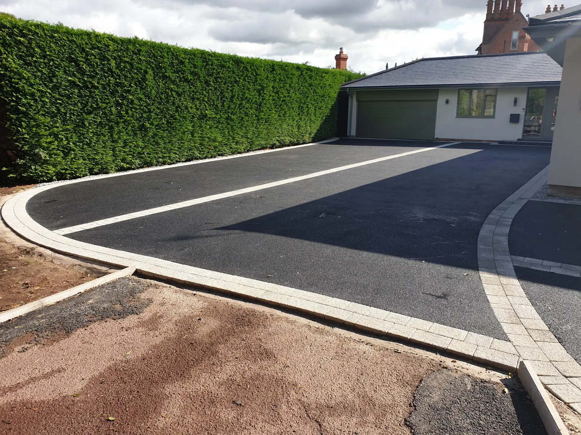 Driveway in Nottingham combining block paving with tarmac for enhanced style and durability.
