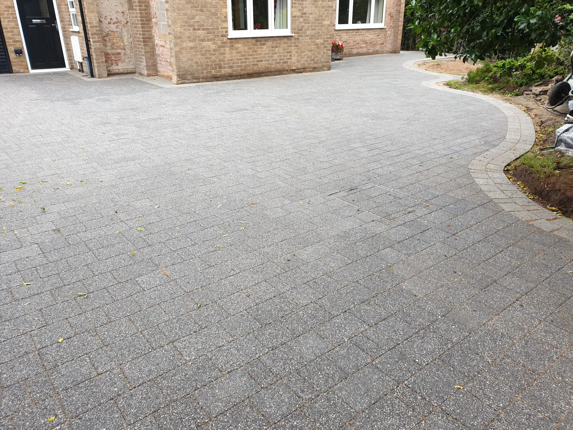 Curved block paved driveway leading to a residential home in Nottingham, showcasing the expert installation and seamless integration into the property landscape.